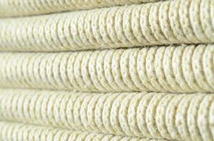 Composition of a soft yellow knitted sweater. Macro texture of bindings in yarns photo