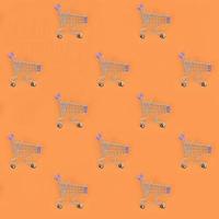 Shopping addiction, shopping lover or shopaholic concept. Many small empty shopping carts perform a pattern on a pastel colored paper background. Flat lay composition, top view photo