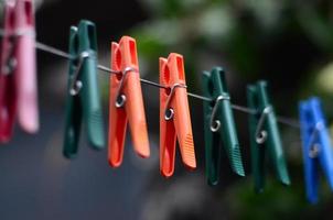 Clothespins on a rope hanging outside house and apple tree photo