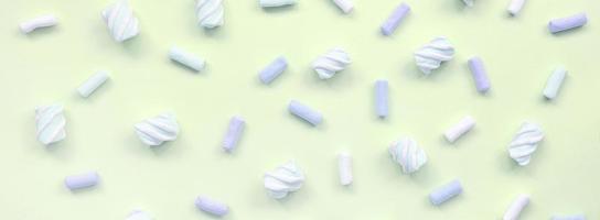 Colorful marshmallow laid out on lime paper background. pastel creative texture photo