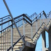 A fragment of a stepped ascent to the pedestrian bridge between the platforms of the railway station photo