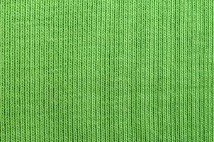 The texture of the fabric is bright green. Material for making shirts and blouses photo