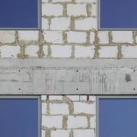 Fragment of an unfinished structure of a multi-storey building made of large concrete bricks photo