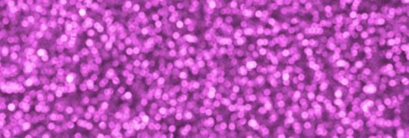 Blurred pink decorative sequins. Background image with shiny bokeh lights from small elements photo