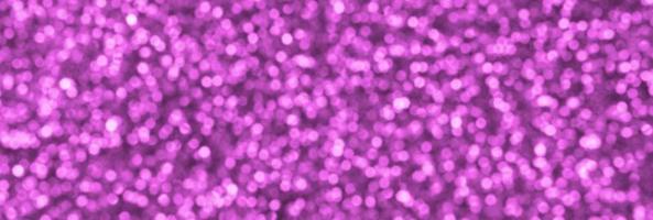 Blurred pink decorative sequins. Background image with shiny bokeh lights from small elements photo