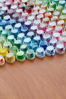 A pattern from a many nozzles from a paint sprayer for drawing graffiti, smeared into different colors. The plastic caps are arranged in many rows forming the color of the rainbow photo