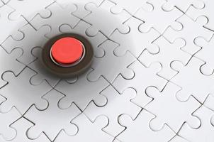 A wooden spinner spins on a white jigsaw puzzle background photo