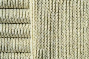 Composition of a soft yellow knitted sweater. Macro texture of bindings in yarns photo