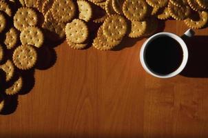 Small coffee cup and salted cracker photo