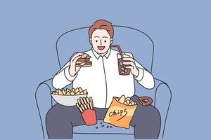 Over weight and unhealthy eating concept. Young smiling man cartoon character sitting in armchair eating burger french fries and drinking lemonade vector illustration