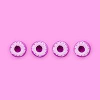 Many small plastic donuts lies on a pastel colorful background. Flat lay minimal pattern. Top view photo