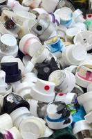 A pattern of many used and soiled nozzles from spray cans with aerosol paint. Background texture of the street art of drawing graffiti on the walls photo