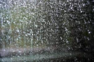 Background image of rain drops on a glass window. Macro photo with shallow depth of field