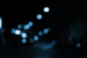 Blurred night scene of traffic on the roadway. Defocused image of cars traveling with luminous headlights. Bokeh Art photo