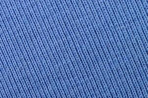 The texture of the fabric in blue color. Material for making shirts and blouses photo