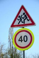 Road sign with the number 40 and the image of the children who run across the road photo