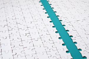 The blue path is laid on the platform of a white folded jigsaw puzzle. Texture image with copy space for text photo