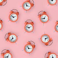 Wasting time concept. Many coral red alarm clock photo