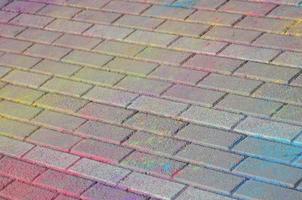 Multi colored paving slabs, powder coated with dry colors at the Holi festival photo