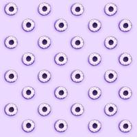 Many small plastic donuts lies on a pastel colorful background. Flat lay minimal pattern. Top view photo