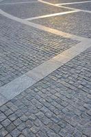 Fragment of the street square, folded out of a gray square paving stone photo