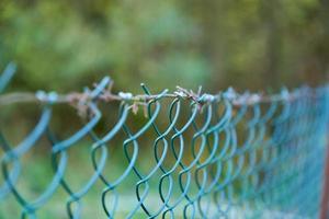 Fence made of intertwined metal mesh at low depth of field. photo