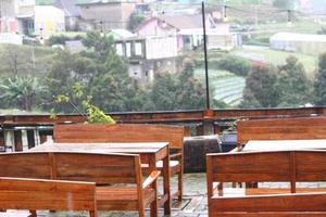 photo of some empty chairs on the outside of the cafe during the day