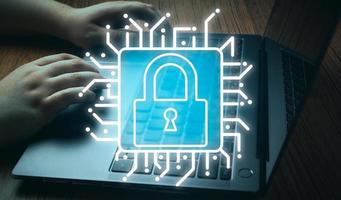 Cyber security network concept. Background of hands typing on laptop with flare light effect and security lock graphic. Digital Data Protection. Defense against danger. photo