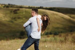 crazy young couple emotionally having fun, kissing and hugging outdoors. Love and tenderness, romance, family, emotions, fun. having fun together photo