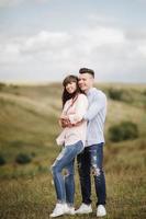 Happy young couple hugging and laughing outdoors. Love and tenderness. Lifestyle concept photo