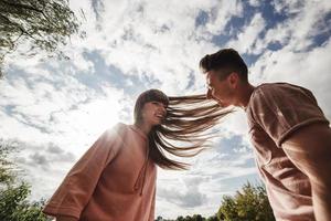 crazy young couple emotionally having fun, kissing and hugging outdoors. Love and tenderness, romance, family, emotions, fun. having fun together photo