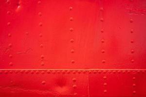 texture background with red metal wall with rivets photo