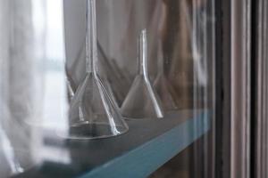 Funnel for a chemical laboratory on a cabinet shelf. photo