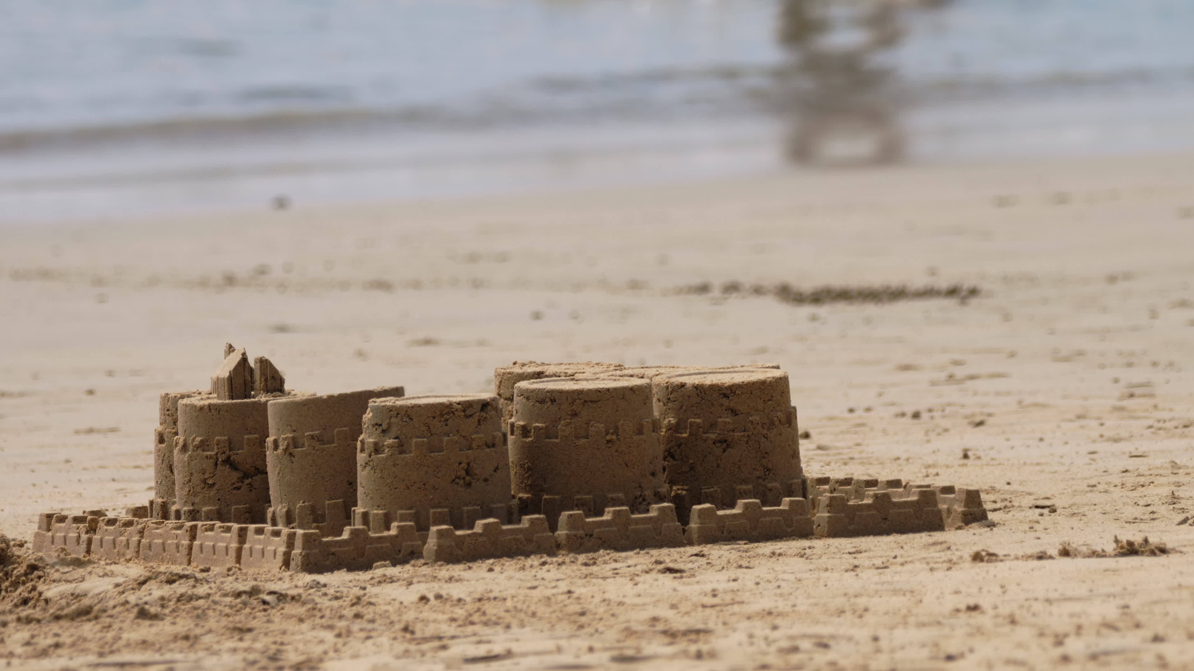 Castles made of sand and sea waves in background 13928118 Stock Video