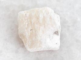 raw Gypsum stone on white marble photo