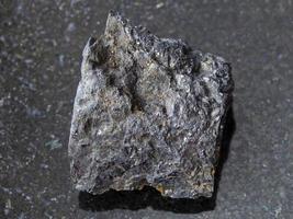 rough Bituminous coal stone on dark background photo