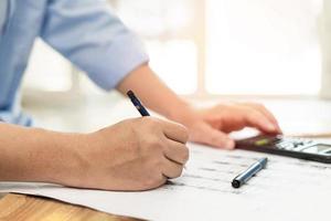 Working man use pencil white document on the table in engineering work photo