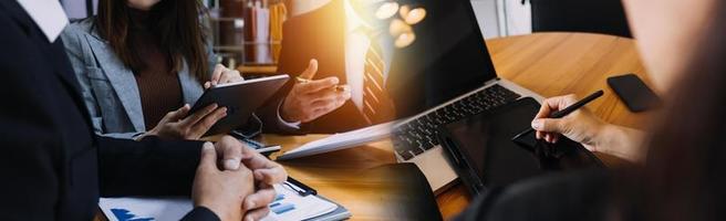 Businessman hands working with finances about cost and calculator and laptop with tablet, smartphone at office in morning light photo