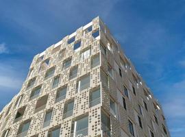 Exterior of modern white openwork house. Architectural detail of close-up on windows and texture wall. Real estate, residential apartment and office. Living apartments or office building architecture. photo