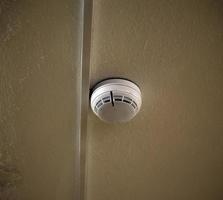 A fire sensor on the ceiling. Fire protection system in the form of a white box. photo