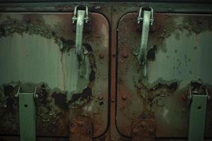 Rust on metal. Field kitchen door. Rust on green paint. Old machine in detail. photo