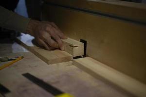 Wood processing. Carpenter's hand. Details of work in carpentry workshop. photo