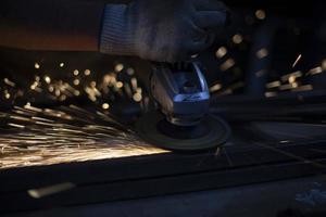 Grinding of steel. Sparks from metal. Hot particles. photo