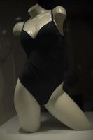 Mannequin in underwear. Women's underwear on showcase. Black clothes. photo