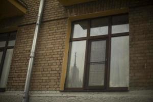 Large window in old house. High window. Details of wall of brick house. photo