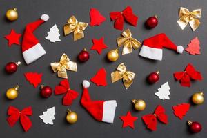 Top view of black background with New Year toys and decorations. Christmas time concept photo