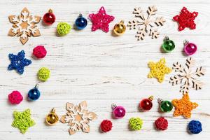 Top view of Christmas decorations and toys on wooden background. Copy space. Empty place for your design. New Year concept photo