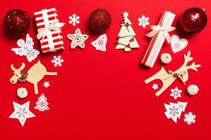 Top view of Christmas decorations on red background. New Year holiday concept with copy space photo