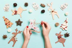 Top view of skates in female hands on blue background. Christmas decorations. New Year holiday concept photo