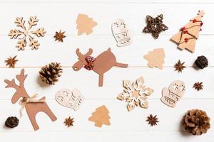 Top view of Christmas toys on wooden background. New Year ornament. Holiday concept photo